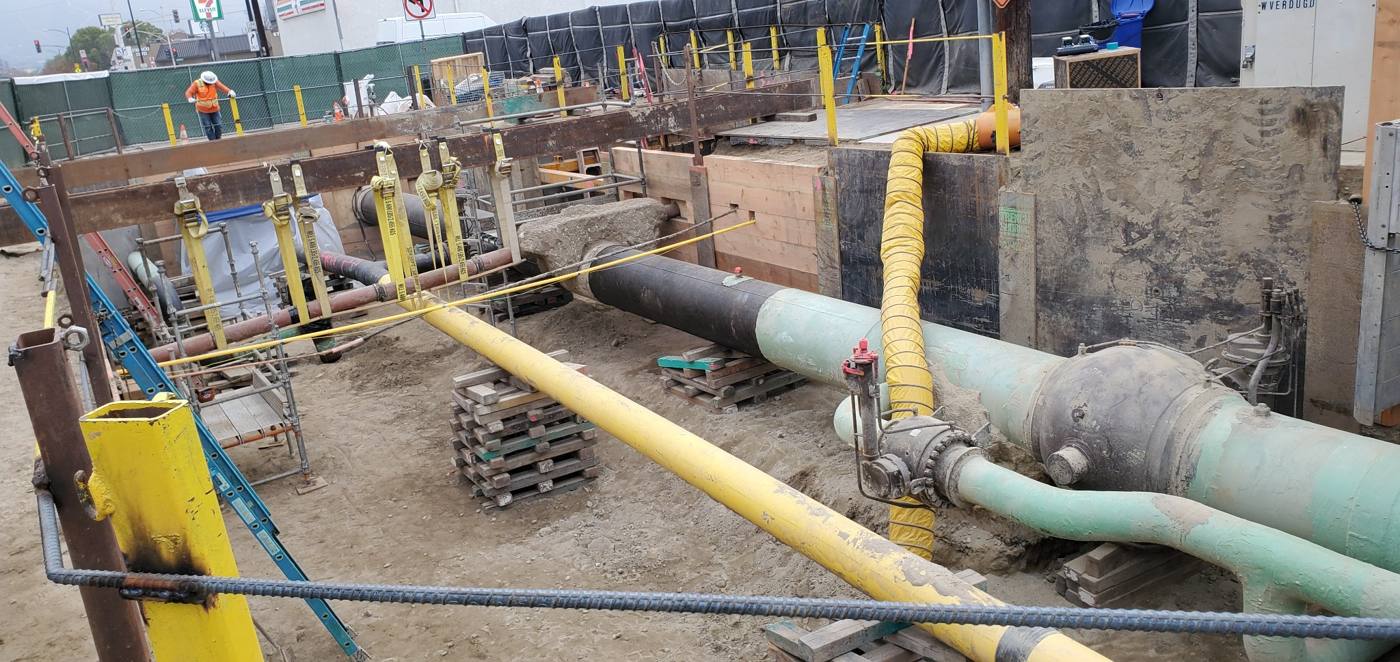 Pipeline excavation with shoring and traffic control along a city street